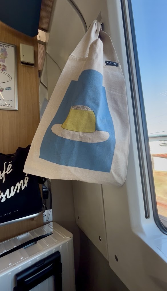 ささきたけよしさんの「スロー商店」で『ケアギフト』の装丁「プリン」の再生コットンエコバッグが発売しています！この度は秋田でご本人からいただいてホクホクと帰りました。（スーパーつがる車内より）