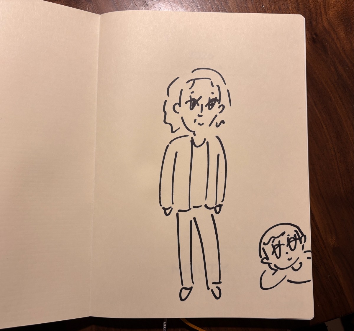 2026年の手帳に大橋さんにイラストを描いてもらう。寝転がっているのは大橋さん